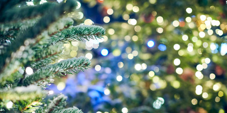 Christmas tree covered snow with yellow garlands lights and bokeh copy space with sparkled lights