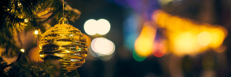 Christmas tree decorations covered snow, outdoor xmas tree with decorative yellow bulbsの写真素材
