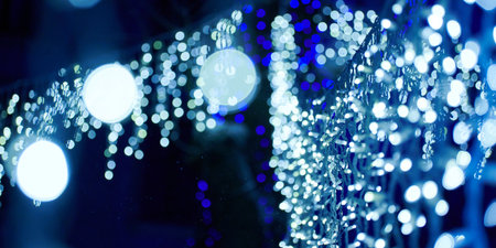 Blue lights bokeh from christmas holiday garlands, blurred festive background, abstract lights