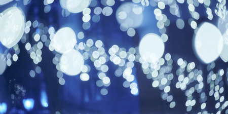 Blue lights bokeh from christmas holiday garlands, blurred festive background, abstract lights