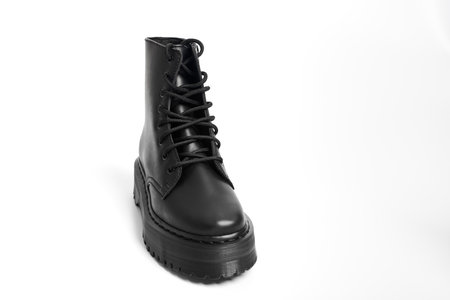 One black women combat boot on high heel platform with lug sole on isolated white backgroundの写真素材
