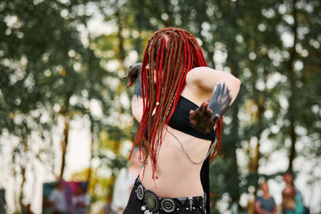 Mythological dancing girl faun on green lawn in public park outdoor art dancing eventの写真素材