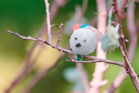 Artificial bird on pink tree branch children crafts in kindergartenの写真素材