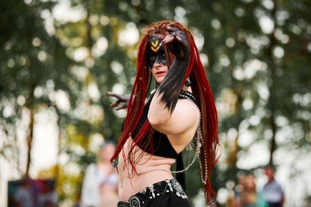 Mythological dancing girl faun on green lawn in public park outdoor art dancing event