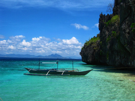 Making a break of riding between magnificent rock formations on a turquoise sea somewhere in paradiseの写真素材
