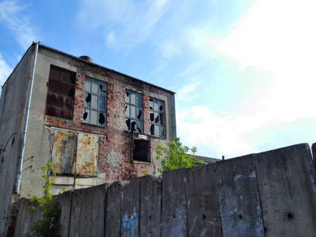Abandoned factory building in Poland with blue sky and white clouds.の写真素材