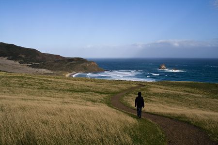 Lonely girl walking through a Rural Landscape in New Zealandの写真素材