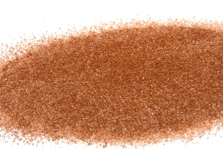 a pattern of sugar with cinnamon on white background