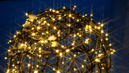 christmas lights in the shape of a Christmas tree on a blue backgroundの写真素材