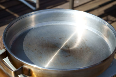 Close up of stainless steel pan on the terrace of a restaurant