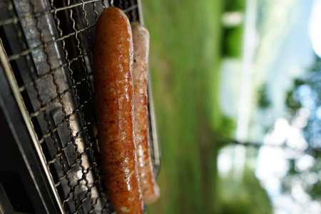 Bake sausages on a portable grillの写真素材
