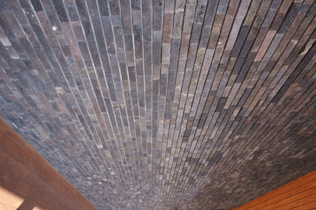 The uneven tiled outer wall of the store