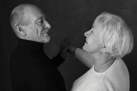 Portrait of endless love. Black and white portrait of happy senior couple looking at each other and...