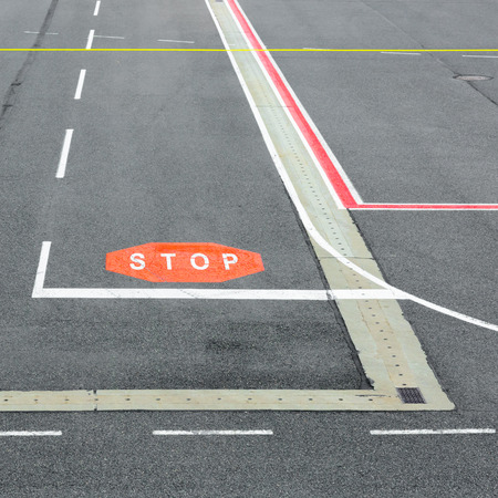 Airport runway and taxiway with marking and signs.の写真素材