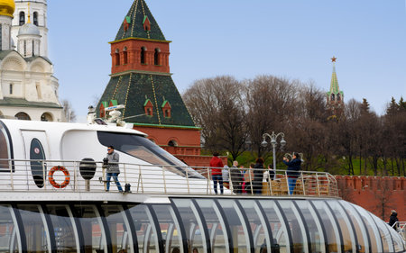 MOSCOW - APRIL 21, 2017: Tourist boat floats on the Moskva River past the Moscow Kremlin, Russia