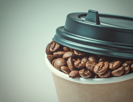 Paper Coffee cup with Coffee Beans backgroundの写真素材