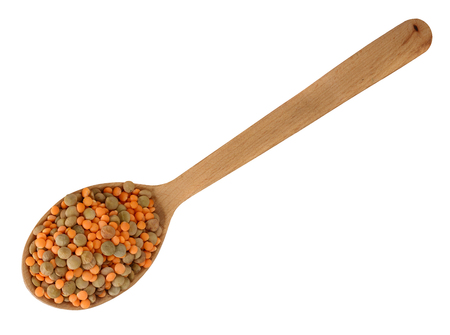 Lentils in the wooden spoon isolated on white backgroundの写真素材