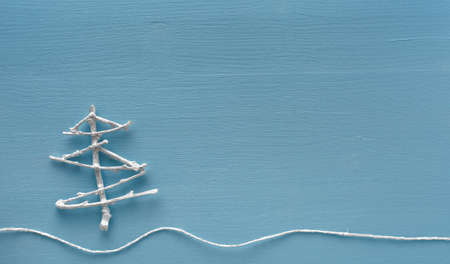 Handmade Christmas tree decoration on blue background
