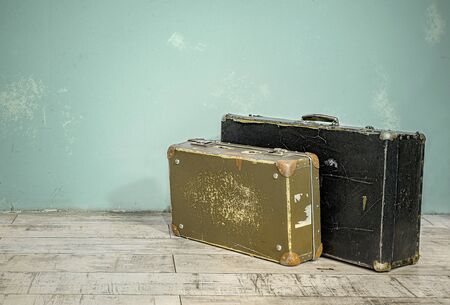 Old suitcases near the wall in an empty room