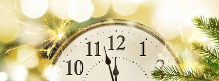 Retro style clock New Years Eve with christmas and new year blurred bokeh backgroundの写真素材