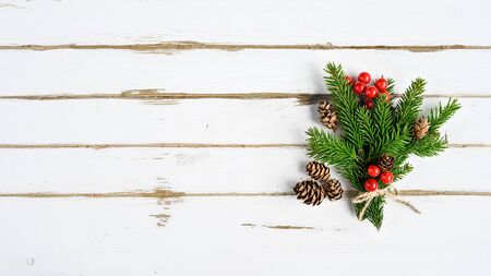 Christmas tree branch on white wooden planksの写真素材