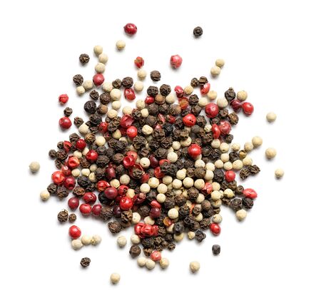 Heap of various pepper peppercorns isolated on white. Top viewの写真素材