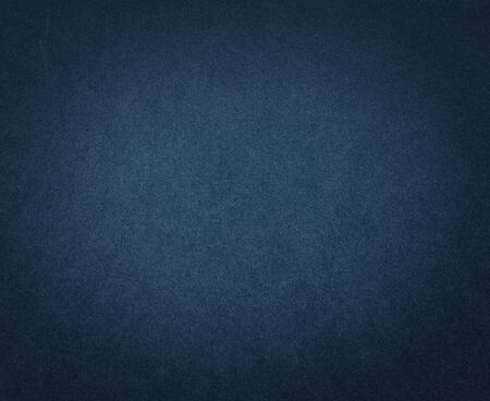 Dark blue paper texture or background. Blue Cardboard with dark vignette.の写真素材