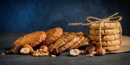 Various Delicious Chocolate chips and nut cookies on dark blue background.の写真素材