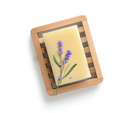 Natural homemade lavender soap with lavender flowers on wooden soap dish on white background. Top...
