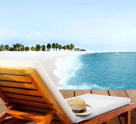 Beach lounger on wooden deck terrace on the beach with beautiful seascape lagoon and palm trees