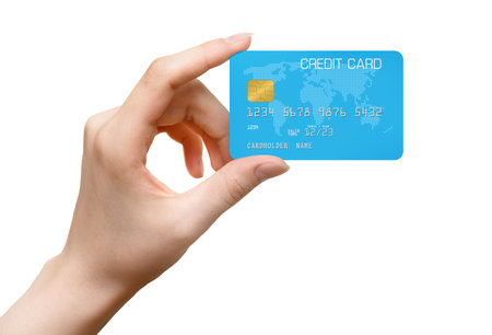 Womans hand holding blue bank card isolated on a white backgroundの写真素材