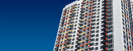 New block of flats building on blue background.