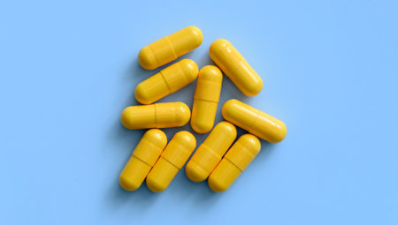 Yellow medicine pills on a blue backgroundの写真素材