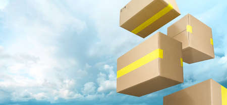 Brown delivery boxes flying on blue sky with clouds background