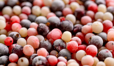Frozen berries of varieties currants background. Frozen fruits mix