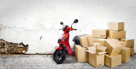 Express delivery service by motorcycle. Red motorcycle with lots of delivery boxes on the street and wall background.の写真素材