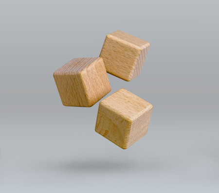 Wooden blocks flying over grey background.の写真素材