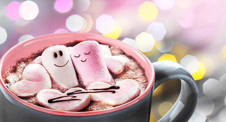 A couple in love made of marshmallows with hearts in a mug with hot chocolateの写真素材