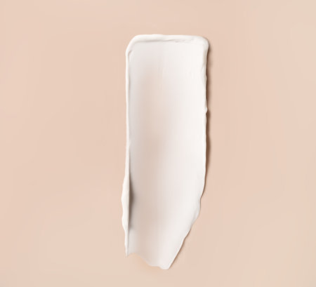 Moisturizing cream stroke isolated on skin-color backgroundの写真素材