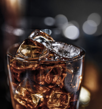 Refreshing Cola cocktail with chilled ice cubes