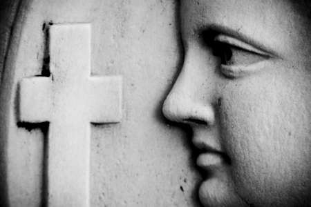 Religious wall detail with face and cross.