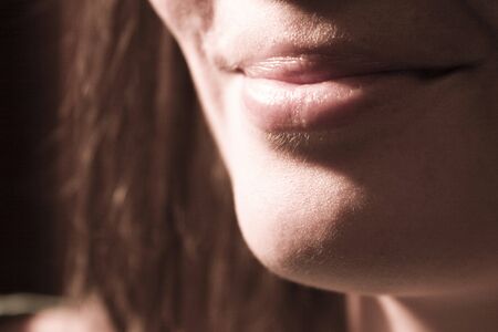 Closeup of discreet woman smileの写真素材
