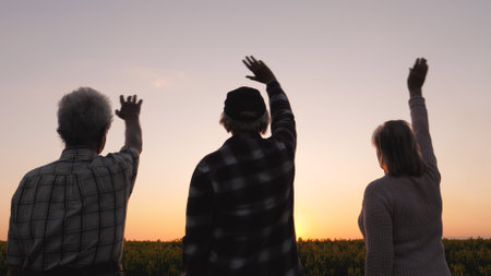 Family People Wave Goodbye To Sun At Sunset In Rural Field