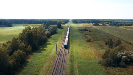 Aerial View Electric Locomotive With Passenger Or Cargo Wagon Rides By Rail