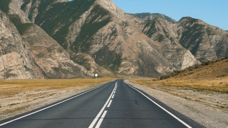 Motion On Highway Going To Rocky Mountain Range Through Desert Prairie