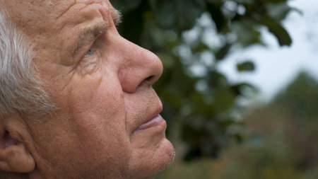 Portrait Elderly Old Man Looks Up At The Sky With Hopeの写真素材