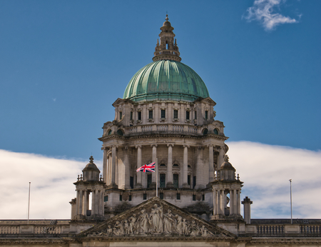 Dome of the town hall in Belfast in nice weather with figures and the English flagの写真素材