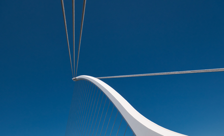 White bridge pillar stretched with steel ropes and blue sky in the backgroundの写真素材