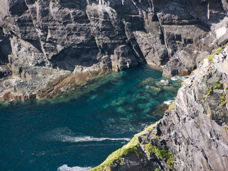 The view from above into a bay with clear water at the Cliff of Kerry in Irelandの写真素材