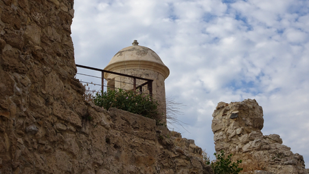 A watchtower with a round dome of a fortress on a thick stone wallの写真素材